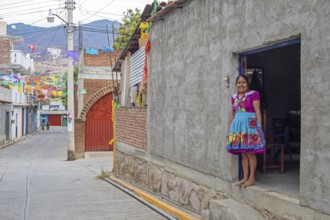 San Miguel del Valle, Oaxaca, Mexico, Epifania Hernandez Garcia stands in the doorway of her shop,