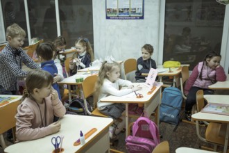 Pupils in a classroom in one of the metro schools in Kharkiv. Classrooms were set up in various