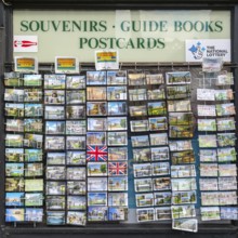 Postcards on display outside The Parade Shopper souvenir shop store in city centre, Cambridge,