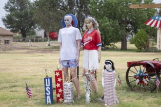 Laverne, Oklahoma, A patriotic family is part of a display in front of a rural Oklahoma home