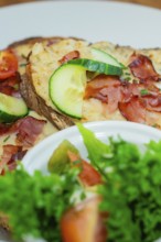 Close-up of a loaf of bread with vegetables and salad on a plate, autumn creations, Cafe Kuh,