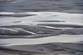 Detail, structure, river course in a gravel bed with black sand, meandering river, Dímonarhellir,