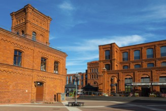 Historic brick building with windows under a clear blue sky, Manufaktura, Lódz, Lodz, Lodz, Poland,