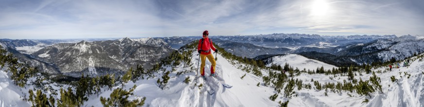 Ski tourer at the summit of Simetsberg, panorama with Walchensee, mountain panorama, Estergebirge,