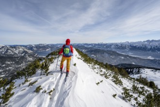 Ski tourer at the summit of Simetsberg, mountain panorama, Estergebirge, Bavarian Prealps, Bavaria