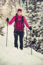 A woman's ski tour at sunrise on the Tegelberg in the Allgäu in the Ammergebirge, Bavaria, Germany,