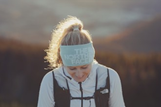 Trail running in autumn on the Jochberg on Lake Walchensee against the wonderful backdrop of the