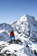 Ski tourers on foot, mountain panorama with snow-covered mountain landscape in winter, view of