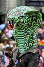 Person masked as a snake head at the carnival parade of the Wey guild on Rose Monday, Güdismäntig,