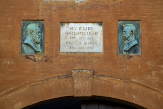 Commemorative plaque with portraits of H. V. Bissen and Vilhelm Bissen above entrance gate, studio,