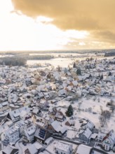 Snowy village with church, warm sunlight breaking through the clouds, Calw, Altburg, district Calw,