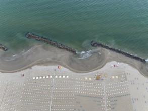 Bathing beach in Rimini. Bathing beach on the Adriatic in bad weather. All deckchairs are free.