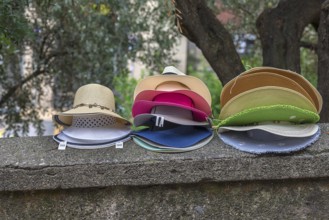 Sun hats on a wall for sale, Genoa, Italy, Europe