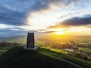 Sunrise over Glastonbury Tor from a drone at autumn, Glastonbury, Somerset, England, United