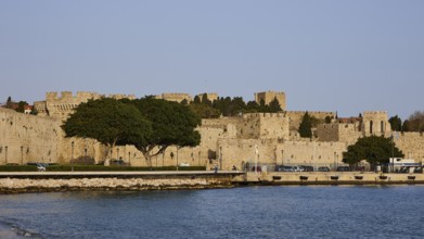 The fortress walls on the coast form a peaceful retreat next to the clear water, Outer city walls,