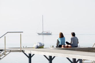 Two woman on a jetty, Immenstaad, Lake Constance, Baden-Württemberg, Germany, Europe