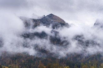 View of part of the Tennengebirge from Oberscheffau. The mountains are covered in clouds. Autumn.