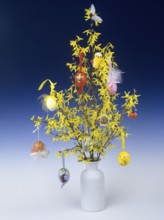 Easter bush of flowering forsythia, hung with colourful Easter eggs