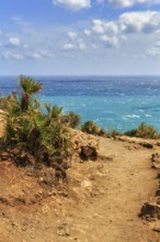 Hiking trail at Mirador de La Amatista with views of turquoise sea, coastline at La Isleta, sunny