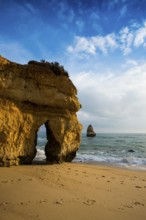 Rocky coast with beach and red rocks, Praia do Camilo, Lagos, Algarve, Portugal, Europe