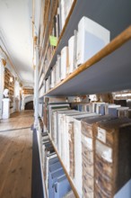 Close-up of bookshelves containing old books standing above a wooden floor, Weimar, Germany, Europe