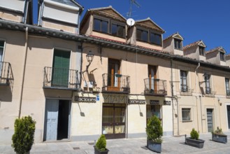 Sunny street scene with buildings, balconies and signs in a Spanish town, Calle de Jose Costa, San