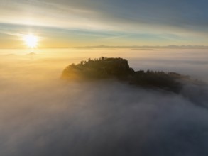 Aerial view of the Hegau volcano Hohentwiel with the upper fortress ruins as a silhouette at