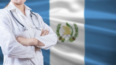 Healthcare concept with Guatemalan flag in background. Doctor with arms crossed with Guatemala flag