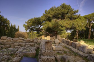 HDR Photo, Remains of Athena Polias Temple, Ancient ruins of stone, surrounded by trees, under blue