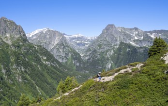 Mountaineer on hiking trail to Aiguillette des Posettes, mountain panorama with summit Mont Bues