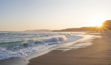 Sandy beach beach and sea at sunset, sun star, Playa Cocalito, coastal landscape, Pacific coast,