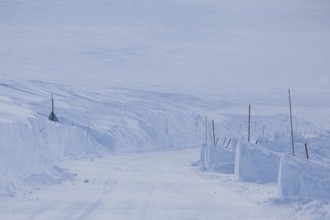 Snow-covered road, snow drifts, winding, winter, Finnmark, Norway, Europe