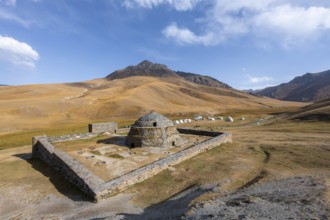 Historic caravanserai Tash Rabat from the 15th century, traditional yurts in the back between