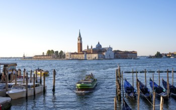 Vaporetto and gondolas, San Giorgio Maggiore church in the background, evening light, Venice,