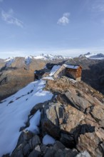 Snowy mountain landscape, mountain hut Ramolhaus in autumn with snow, in the evening light, view of