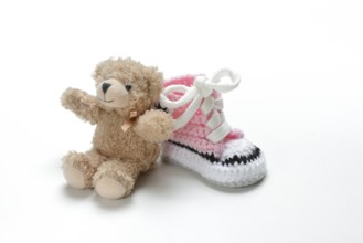 Pink baby shoe with teddy bear