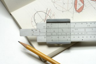 Slide rule on book, calculating aid