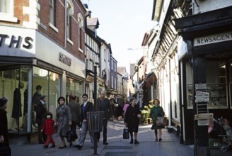 Strollers in the narrow medieval pedestrian street Drapers Lane in the city centre of York,