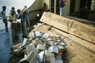 Cardboard boxes labelled Goods for Locals on board a ship, Guyana, West Indies, South America, 1960