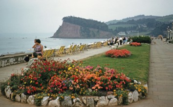 Flowers and lawns, walkers on the promenade, Teignmouth, Devon, England, United Kingdom, early