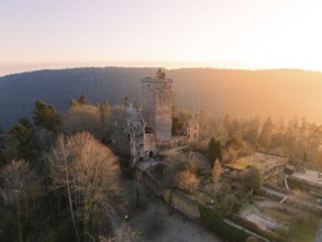 An impressive castle ruin in the forest at sunset creates a majestic atmosphere, Zavelstein,