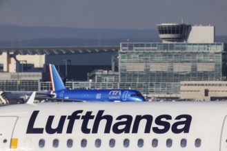 Lufthansa Group aircraft in front of the terminal at Fraport Airport. Lufthansa logo and Airbus