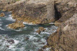 Rocky west coast of the Quiberon peninsula in Brittany, France. Crashing waves and rocks