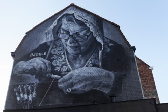 Mural Lace maker with lace bonnet at work, realistic mural in black and white by street artist