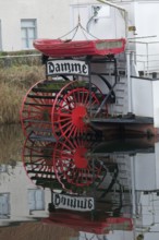 Red paddle wheel and red lifeboat, nostalgic paddle steamer Lamme Goedzack on the canal from Damme