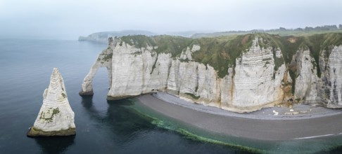 Aerial view of La Porte d'Aval and l'Aiguille on the Alabaster Coast in light fog, Etretat,