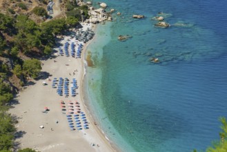 Overview of a sunny Apella beach, with turquoise-coloured water and many sunshades, Apella beach,