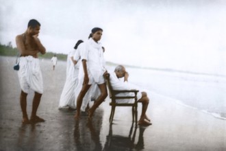 Mahatma Gandhi sitting on chair and Devdas Gandhi on Juhu Beach, Mumbai, Maharashtra, India, May