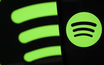 Spotify logo is seen on a smartphone