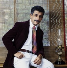 Portrait of Naseeruddin Shah sitting on table, India, Asia